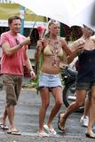 Tara Reid in a bikini top and denim mini